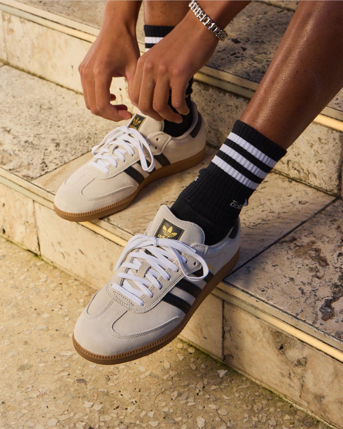 Beige adidas Samba sneakers on stone steps